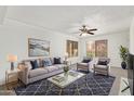 Stylish living room showcasing a comfortable sofa, elegant decor, and plenty of natural light from windows at 1905 E University Dr # 139, Tempe, AZ 85288
