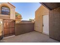 Private condo patio featuring a gated entrance and an enclosed storage area, perfect for outdoor living at 1905 E University Dr # 139, Tempe, AZ 85288