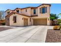 Charming two-story house showcasing a three-car garage, a spacious driveway, and well-kept landscaping at 19415 W Colter St, Litchfield Park, AZ 85340