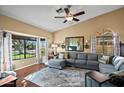 Inviting living room with a large window, comfortable seating, and hardwood flooring at 20657 N 56Th Ave, Glendale, AZ 85308