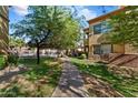 Beautifully landscaped walkway leading to condos with lush greenery at 2134 E Broadway Rd # 2031, Tempe, AZ 85282
