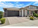 Beautiful single-story home with a two-car garage and desert landscaping, perfect for low-maintenance living at 22476 E Indiana Ave, Queen Creek, AZ 85142