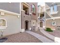 Stylish townhome exterior with walkway, balcony, and inviting entrance at 2401 E Rio Salado Pkwy # 1048, Tempe, AZ 85288