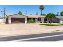 Lovely ranch-style home with a well-kept lawn and a spacious driveway at 3050 E Cholla E St, Phoenix, AZ 85028