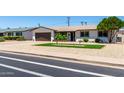 Single story home featuring desert landscaping and mature trees in a suburban neighborhood at 3050 E Cholla E St, Phoenix, AZ 85028