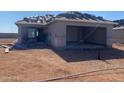 New home under construction, featuring the start of a new roof and an attached two-car garage at 32282 N Pony Express Rd, San Tan Valley, AZ 85143