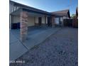 Cozy home with covered carport, side gravel and convenient trash storage at 3328 E Crescent Ave, Mesa, AZ 85204
