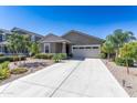 Charming single-story home with desert landscaping, a neutral color and a spacious two car garage at 36076 W Santa Barbara Ave, Maricopa, AZ 85138