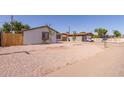 Exterior view of home, showcasing desert landscaping, wood fence, and a well-maintained exterior at 3812 W Seldon Ln, Phoenix, AZ 85051