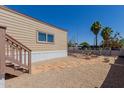 Single-Gathering home's backyard with stone pavers, desert landscaping, and mature trees at 3952 E Baywood Ave, Mesa, AZ 85206