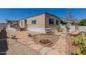 Single-Gathering home with a walkway, desert landscaping, and a cozy front patio at 3952 E Baywood Ave, Mesa, AZ 85206