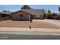 Front exterior featuring a well-kept brick home with a paved driveway and desert landscaping at 4112 S Grandview Ave, Tempe, AZ 85282