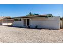 Rear view of the house with low-maintenance yard, security door and desert landscaping at 539 E Pebble Beach Dr, Tempe, AZ 85282