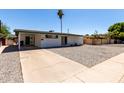 View of the house from the side showing carport and a long driveway at 539 E Pebble Beach Dr, Tempe, AZ 85282