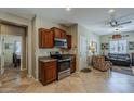 Well-lit kitchen featuring wooden cabinets, stainless steel appliances, and tiled floors at 549 E Quentin Ln, San Tan Valley, AZ 85140
