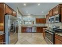 Modern kitchen featuring stainless steel appliances, granite countertops, and tile flooring at 549 E Quentin Ln, San Tan Valley, AZ 85140