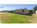 Spacious side yard offers lush green grass and ample space, perfect for outdoor activities at 6009 W Medlock Dr, Glendale, AZ 85301