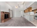 Inviting living room featuring high ceilings, a fireplace, and seamless kitchen access at 633 W Southern Ave # 1181, Tempe, AZ 85282