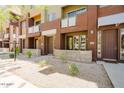 Exterior of a row of townhomes with a gravel yard and concrete walkways, showing multiple units at 6605 N 93Rd Ave # 1035, Glendale, AZ 85305