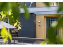 Inviting entrance with a unique teal door, modern architecture, and manicured landscaping at 706 E Washington St # 124, Phoenix, AZ 85034