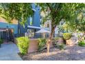 Stylish exterior featuring multiple levels with private patio space and mature landscaping at 706 E Washington St # 124, Phoenix, AZ 85034