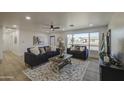 Bright living room featuring two blue sofas, hardwood floors, and a large window at 7428 E Cambridge Ave, Scottsdale, AZ 85257