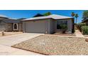 Cozy single-story home with a two-car garage, complemented by desert landscaping at 8720 W Willowbrook Dr, Peoria, AZ 85382