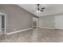 Spacious living room featuring tile floors, ceiling fan, and sliding glass door to the backyard at 8720 W Willowbrook Dr, Peoria, AZ 85382