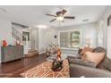 Cozy living room featuring stairs, neutral walls, hardwood floors, and ceiling fan at 905 S Osborn Ln, Gilbert, AZ 85296