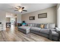 Bright living room featuring wood floors, neutral tones, a gray couch and a ceiling fan at 932 W Julie Dr, Tempe, AZ 85283