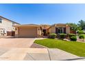 Beautiful single-story home featuring a paved driveway and manicured lawn at 1229 W Sycamore Rd, Queen Creek, AZ 85140