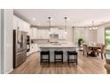 Modern kitchen with an island, stainless steel appliances, and a dining area at 1229 W Sycamore Rd, Queen Creek, AZ 85140