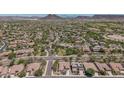 Gorgeous aerial view of a desert community with mountain views and lush landscaping at 12360 W Eagle Ridge Ln, Peoria, AZ 85383