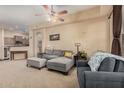 Comfortable living room featuring a plush gray sectional sofa, ceiling fan, and an open layout at 14575 W Mountain View Blvd # 12309, Surprise, AZ 85374