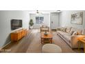 Bright living room with modern furniture, neutral tones, and stylish wood flooring at 1595 S 227Th Ave, Buckeye, AZ 85326