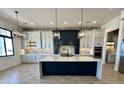 Modern kitchen with a large island, stainless steel appliances, and beautiful backsplash tile at 1650 W Lucky Ln, Queen Creek, AZ 85144