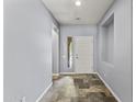 Inviting foyer featuring neutral walls, tile flooring, and a view of the front door at 16762 W Sonora St, Goodyear, AZ 85338