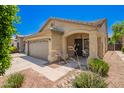 Inviting single-story home with a two-car garage, covered porch, and low-maintenance landscaping at 16821 S 23Rd St, Phoenix, AZ 85048