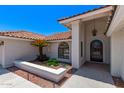 A beautiful entrance with desert landscaping and a ornate front door at 17025 E De Anza Dr, Fountain Hills, AZ 85268