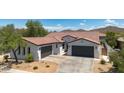 Attractive single-Gathering home boasts a three-car garage, desert landscaping, and a terracotta roof at 1720 W Aloe Vera Dr, Phoenix, AZ 85085