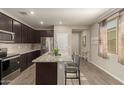 Stylish kitchen island with granite countertops and room for seating at 17444 W Via De Luna Dr, Surprise, AZ 85387