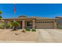 Charming single-story home featuring a neutral color scheme, well-maintained landscaping, and an American flag at 17796 W Andora St, Surprise, AZ 85388