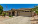 Charming single-story home featuring a neutral color scheme and a well-maintained xeriscaped front yard at 17796 W Andora St, Surprise, AZ 85388