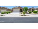 A street view of attractive single-Gathering homes showcasing well-maintained landscaping and curb appeal at 18027 W Tina Ln, Surprise, AZ 85387