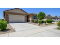 This lovely home boasts a two-car garage, desert landscaping, and a welcoming entrance at 18027 W Tina Ln, Surprise, AZ 85387
