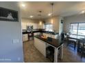 Modern kitchen featuring stainless steel appliances, sleek black countertops, and a functional center island at 1814 W Minton St, Phoenix, AZ 85041