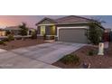 Lovely gray single-Gathering home with desert landscaping, a spacious driveway, and ample parking at 19531 W Palo Verde Dr, Litchfield Park, AZ 85340