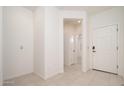 Bright entryway featuring neutral paint and tile flooring, leading into the home at 1965 N 213Th Dr, Buckeye, AZ 85396