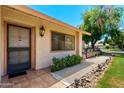 Inviting front entrance featuring tile flooring, a secure screen door, and a well-lit walkway at 212 Leisure World --, Mesa, AZ 85206
