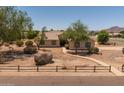 Charming home with mature trees, desert landscaping, and a welcoming walkway leading to the entrance at 22201 E Vallejo St, Queen Creek, AZ 85142